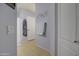 Hallway featuring a bathroom, linen closet, and neutral tiling at 709 E Dry Creek Rd, San Tan Valley, AZ 85143