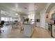 Open kitchen featuring a spacious island, stainless steel appliances, and white cabinetry at 709 E Dry Creek Rd, San Tan Valley, AZ 85143