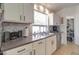 Kitchen featuring neutral countertops, stainless steel dishwasher, and bright natural light at 709 E Dry Creek Rd, San Tan Valley, AZ 85143