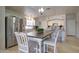 Eat-in kitchen with a dining table, island, stainless steel refrigerator, and white cabinets at 709 E Dry Creek Rd, San Tan Valley, AZ 85143
