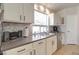 Kitchen featuring neutral countertops, stainless steel dishwasher, and bright natural light at 709 E Dry Creek Rd, San Tan Valley, AZ 85143