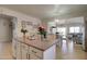 Open kitchen featuring a large island, stainless steel refrigerator, and modern decor at 709 E Dry Creek Rd, San Tan Valley, AZ 85143