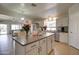 Bright kitchen featuring a large island, white cabinets, stainless steel appliances, and an open floor plan at 709 E Dry Creek Rd, San Tan Valley, AZ 85143