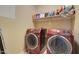 Modern laundry room featuring Samsung washer and dryer with storage shelf at 709 E Dry Creek Rd, San Tan Valley, AZ 85143