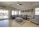 Comfortable living room with a large sectional sofa, vaulted ceilings, and a view of the backyard pool at 709 E Dry Creek Rd, San Tan Valley, AZ 85143