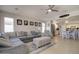 Open living room showcases a cozy sectional sofa, decorative armchair, and seamless access to the kitchen at 709 E Dry Creek Rd, San Tan Valley, AZ 85143