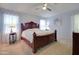 Bright main bedroom showcasing soft carpet, ceiling fan, and natural light through the windows at 709 E Dry Creek Rd, San Tan Valley, AZ 85143