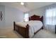 Comfortable main bedroom with soft carpet, ceiling fan, and natural light through the windows at 709 E Dry Creek Rd, San Tan Valley, AZ 85143