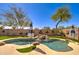 Private pool with waterfall feature and artificial turf, perfect for outdoor relaxation and entertaining at 709 E Dry Creek Rd, San Tan Valley, AZ 85143
