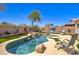 Private pool with water feature, lounge chairs, and blue sky, providing a serene backyard escape at 709 E Dry Creek Rd, San Tan Valley, AZ 85143