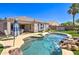 Backyard oasis showcasing a sparkling pool with rock waterfall feature at 709 E Dry Creek Rd, San Tan Valley, AZ 85143
