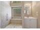 Bathroom featuring a walk-in shower with a glass block window and single vanity at 742 E Kyle Dr, Gilbert, AZ 85296