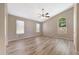 Spacious bedroom featuring wood-look floors, multiple windows, and a ceiling fan at 742 E Kyle Dr, Gilbert, AZ 85296