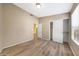 A neutral bedroom features wood-look floors, light-colored walls, and open closet with sliding doors at 742 E Kyle Dr, Gilbert, AZ 85296