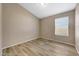 Bedroom featuring wood-look flooring, a window with blinds, and neutral colored walls at 742 E Kyle Dr, Gilbert, AZ 85296