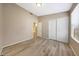 A neutral bedroom features wood-look floors, light-colored walls, and closet with sliding doors at 742 E Kyle Dr, Gilbert, AZ 85296