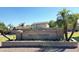 Welcoming community sign for Neely Farms with lush green landscape and palm trees on a clear day at 742 E Kyle Dr, Gilbert, AZ 85296