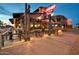 Lively restaurant exterior at dusk featuring outdoor seating, string lights, and a neon sign at 742 E Kyle Dr, Gilbert, AZ 85296