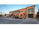 Commercial building featuring brick facade, large windows, and ample parking space at 742 E Kyle Dr, Gilbert, AZ 85296