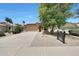 Attractive single-story home featuring a tiled roof, wide driveway, and desert-style landscaping at 742 E Kyle Dr, Gilbert, AZ 85296
