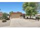 Charming single-Gathering home with a two-car garage, tiled roof, and low-maintenance desert landscaping at 742 E Kyle Dr, Gilbert, AZ 85296