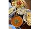 Delicious Indian food with curry, rice, naan, and salad on a restaurant table at 742 E Kyle Dr, Gilbert, AZ 85296