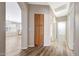 Hallway with view to the kitchen and bathroom, and wood-look flooring at 742 E Kyle Dr, Gilbert, AZ 85296