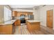 Well-lit kitchen featuring granite countertops, wood cabinetry, and stainless steel appliances at 742 E Kyle Dr, Gilbert, AZ 85296