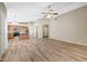 Open-concept living room with high ceilings, ceiling fan, and wood-look flooring at 742 E Kyle Dr, Gilbert, AZ 85296