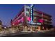 Modern parking garage with pink neon accents and prominent 'Public Parking' signage at 742 E Kyle Dr, Gilbert, AZ 85296