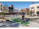 Vibrant street scene featuring pedestrian and bicycle traffic, crosswalks, and diverse storefronts at 742 E Kyle Dr, Gilbert, AZ 85296