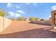 Large, gravel backyard with block fencing, ready for customization and landscaping at 8137 W Pueblo Ave, Phoenix, AZ 85043