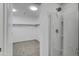 Modern bathroom features a glass shower and spacious walk-in closet with carpet at 8137 W Pueblo Ave, Phoenix, AZ 85043