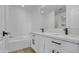 Bright bathroom with double vanity, quartz countertops, and a tub at 8137 W Pueblo Ave, Phoenix, AZ 85043