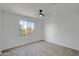 This bedroom is painted white and has a ceiling fan and a window that lets in natural light at 8137 W Pueblo Ave, Phoenix, AZ 85043