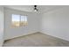 Bright, empty bedroom with large windows and neutral carpet at 8137 W Pueblo Ave, Phoenix, AZ 85043