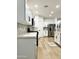 Updated kitchen features stainless steel appliances, quartz countertops, updated cabinetry, and light wood floors at 8137 W Pueblo Ave, Phoenix, AZ 85043