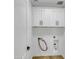 A bright laundry room featuring white cabinets and space for a washer and dryer at 8137 W Pueblo Ave, Phoenix, AZ 85043