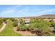 Expansive aerial view of a residential community with lush green spaces and desert mountain views at 8920 S 40Th Ln, Laveen, AZ 85339