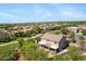 Overhead view of a home with covered patio, nestled in a community with green spaces and city view at 8920 S 40Th Ln, Laveen, AZ 85339