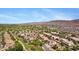 Panoramic aerial view of a community with desert landscaping, golf course, and mountain backdrop at 8920 S 40Th Ln, Laveen, AZ 85339
