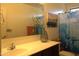 Well-lit bathroom with a single sink vanity and a shower featuring an ocean-themed curtain at 8920 S 40Th Ln, Laveen, AZ 85339