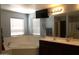 Bright bathroom with soaking tub, separate vanities, and a large mirror, creating a spa-like retreat at 8920 S 40Th Ln, Laveen, AZ 85339