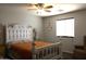 Comfortable bedroom featuring an ornate white bed frame, fan, and bright natural light at 8920 S 40Th Ln, Laveen, AZ 85339