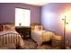 Bright bedroom featuring two twin beds, decorative pillows, and a serene ambiance at 8920 S 40Th Ln, Laveen, AZ 85339