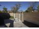 Secure backyard featuring a gated pool area for added safety and privacy, complemented by desert landscaping at 8920 S 40Th Ln, Laveen, AZ 85339