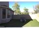 Cozy backyard area with a fire pit and artificial turf, ideal for gathering and enjoying the outdoors at 8920 S 40Th Ln, Laveen, AZ 85339