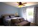 Tranquil main bedroom with a comfortable bed, a plush chaise lounge, and abundant natural light at 8920 S 40Th Ln, Laveen, AZ 85339