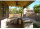 Covered outdoor kitchen features a grill, sink, and mosaic tile countertop overlooking backyard at 8920 S 40Th Ln, Laveen, AZ 85339