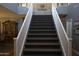 Carpeted staircase with white railing in a home featuring neutral wall colors at 8920 S 40Th Ln, Laveen, AZ 85339